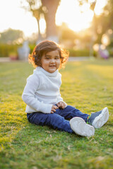 Little boy playing on grass.