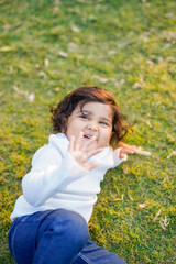 Little boy playing on grass.