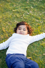 Little boy playing on grass.