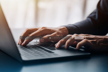 An individual is typing on a keyboard laptop showing a hologram interface to a member login, a...