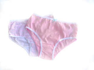 Two panties for girls pink and white with pink stripes close-up on a white background. Children's knitted cotton underwear.	