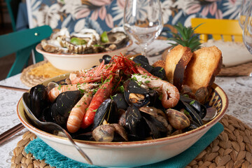 Delicious seafood mussels with shrimp and toast. Clams in the shells ready to eat. Front view. Food concept.