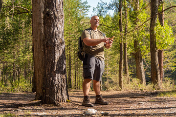 Disoriented hiker lost in the woods, guided by the phone