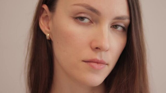 A young brunette woman takes earplugs out of her ear. Noise protection.