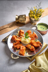 Amritsari fish tikka with raita and lime served in a dish isolated on dark background side view of fastfood