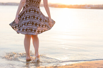 woman dancing on the beach at sunset