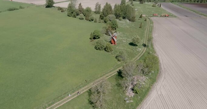  Aerial view of meadows and windmill in the summer at Hammarland, Ahvenanmaa, Finland.
