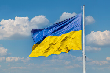 Flag of Ukraine on a background of blue sky. The largest flag in Ukraine.