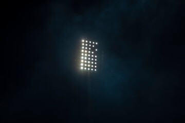 Soccer stadium lights reflectors with smoke and fog. Football field.