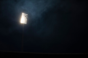 Soccer stadium lights reflectors with smoke and fog. Football field.