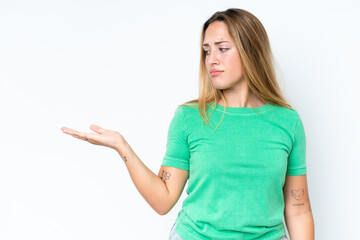 Young caucasian woman isolated on white background holding copyspace with doubts