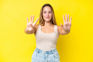 Young caucasian woman isolated on yellow background counting nine with fingers