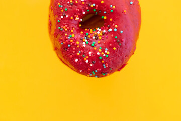 Donuts with sprinkles isolated on yellow background