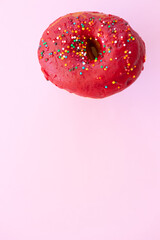 Delicious donut on color pink background