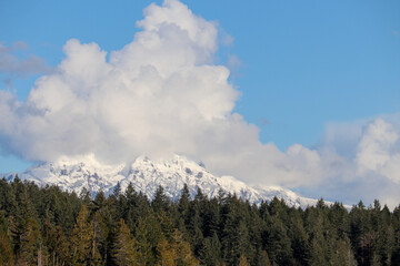 White Puffy Clouds Above the Mountain