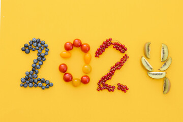 Happy New Year 2024 number made of fruits and berries