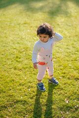 Little boy playing on grass.