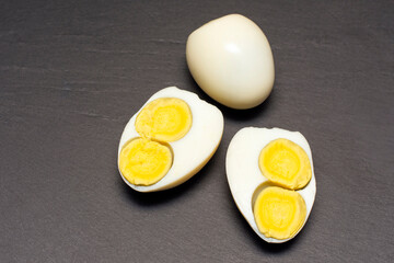 egg with two yolks on a black background.
