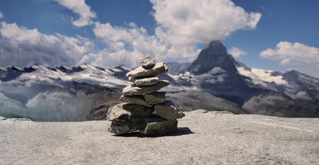 Stack of stones on top of the mountain. Pile of rocks stone and mountains. Balanced stone pyramid...