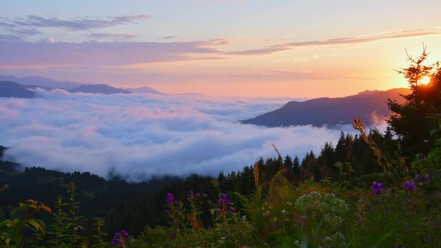 Dramatic sunset time lapse over clouds in Adjara region with clouds pass and sun over horizon .Stunning vibrant sunset background over clouds