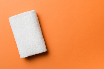 Top view of white towels with copy space on colored background