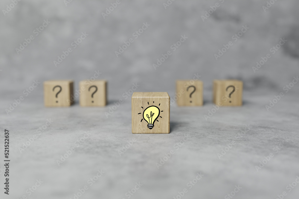 Poster wooden blocks with a question mark and light bulb icon. the concept of finding an answer, an idea. b