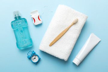 Mouthwash and other oral hygiene products on colored table top view with copy space. Flat lay. Dental hygiene. Oral care products and space for text on light background. concept