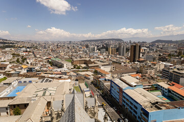 Fototapeta premium beautiful panoramic aerial landscape of the capital of Ecuador, architecture with mountains in the background, day with clouds, exterior with building