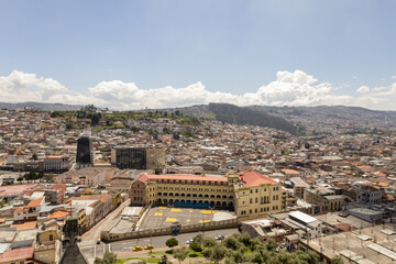 Fototapeta na wymiar panoramic aerial landscape of the capital of Ecuador, architecture with mountains in the background, day with clouds, exterior with buildings in Latin