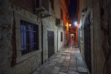 Narrow street of the old town of Kotor at night in Montenegro