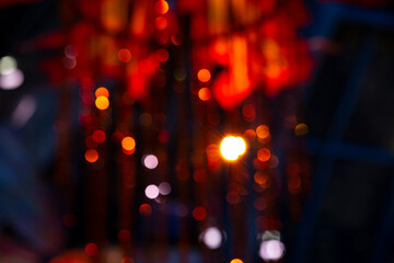 Dancing holiday bokeh lights glowing in deep red tones overlap in a colorful design pattern