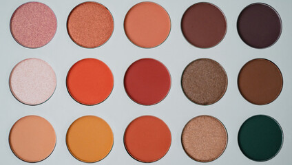 Selective focus of eyeshadow palette with various colors in pearly and matte closeup
