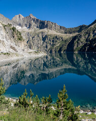 Naklejka na ściany i meble mountain reflection in still blue water lake