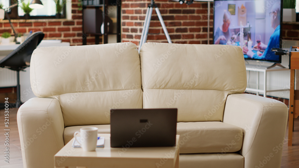 Poster interior of modern apartment with coffee table having laptop on it. empty living room with nobody in