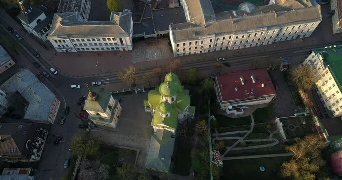 Aerial view streets of Kyiv on which cars drive at beautiful sunset or sunrise. Drone shot old Kiev - podil
