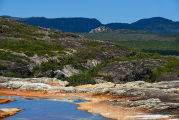Obraz premium Hiking on the shallow natural pools and rocky riverbed of Rio do Lajeado river, Milho Verde, Minas Gerais state, Brazil