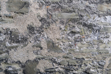 beautiful vintage texture of the wall of a medieval castle built in the middle of the 14th century, multi-colored volumetric stones for the designer, wallpaper, background
