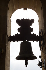 Obraz premium backlighting of a bell in a church steeple in Spain