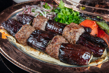 Traditional Turkish kebabs. Eggplant kebab, Adana kebab. With tomatoes, peppers, garlic, bulgur...