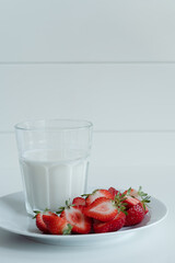 Healthy breakfast with milk and sliced strawberries, healthy meal