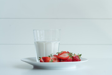 Healthy breakfast with milk and sliced strawberries, healthy meal