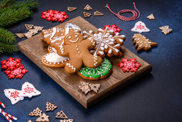Fototapeta na wymiar Christmas homemade gingerbread cookies on a dark concrete table table