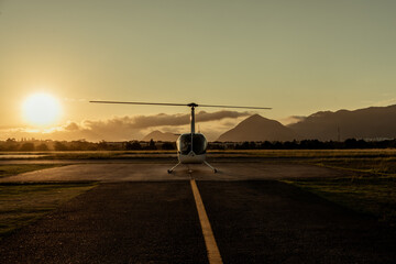 Helicopter at sunset. Airfield.