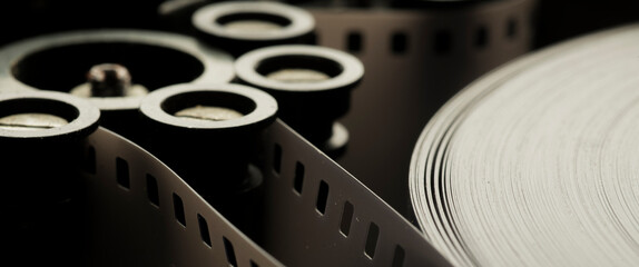 a roll of film in a film camera cassette. negative film in the tape drive mechanism of the...