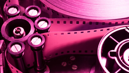 a roll of film in a film camera cassette. negative film in the tape drive mechanism of the...