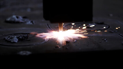 Laser plasma cutting of metal . Clip . Colorful production process at a metallurgical plant .