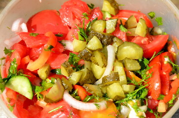 Delicious juicy salad of sliced ​​​​fresh vegetables.