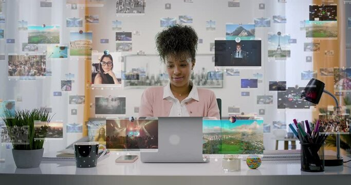 Young Pretty Business Woman Working on Laptop Computer At Home Office. Holographic Social Media Interface Animations Appearing. Social Network. Likes, Comments, Followers.