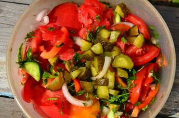 Plastic utensils with cutting juicy vegetables and spices.