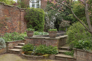 Garden scene with steps and red brick walls